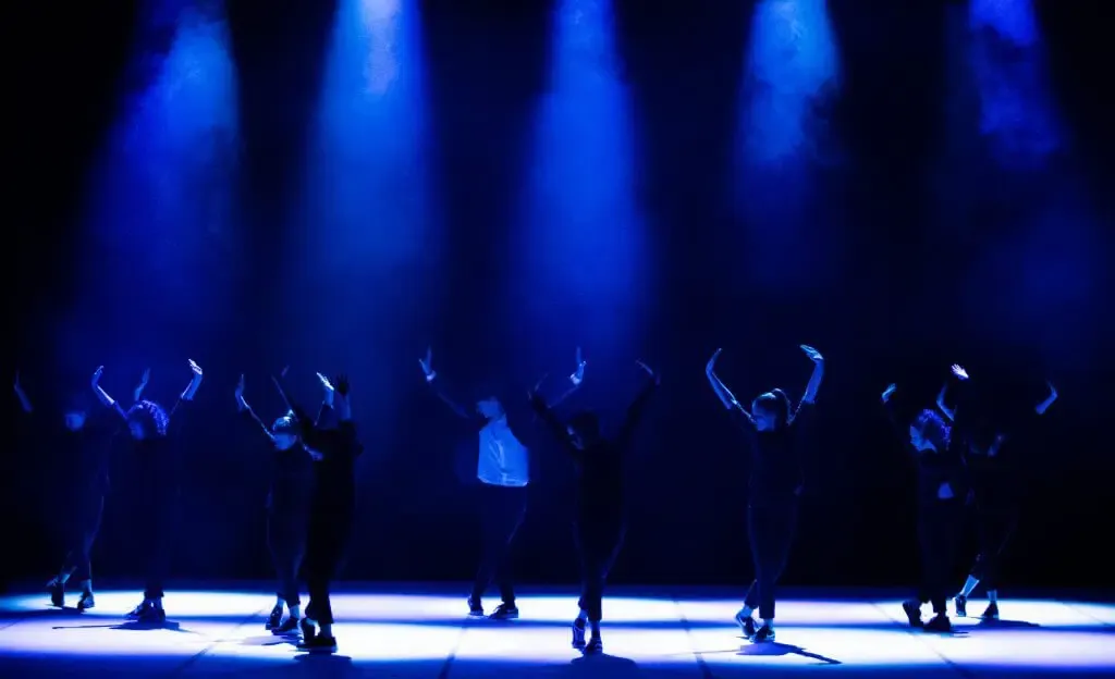 Gruppo di hip hop in scena sotto le luci blu dei riflettori